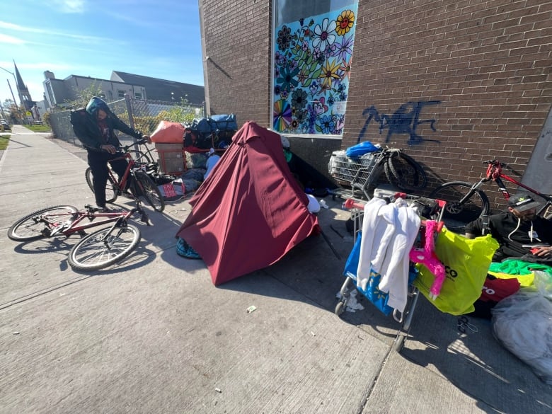 A group of unhoused people at the corner of Lyle Street and Dundas Street West in London's Old East Village. 