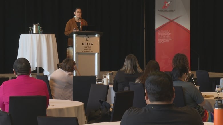 A speaker addresses the audience at a Charlottetown conference.