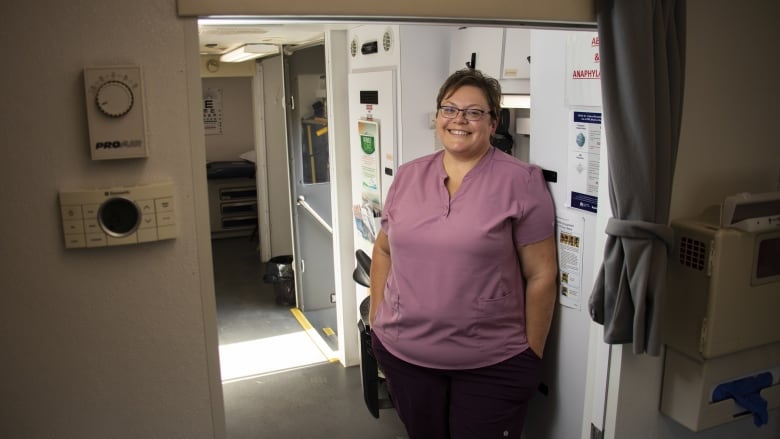 A woman stands in a medical clinic.