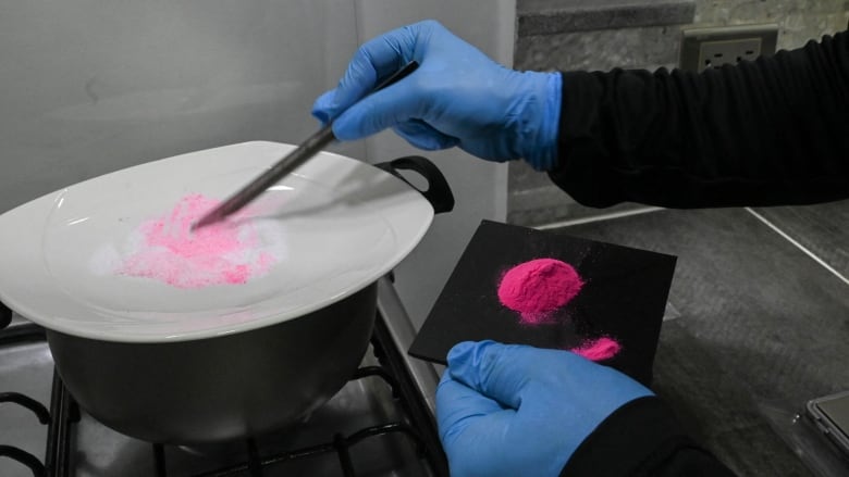 A man prepares pink cocaine.