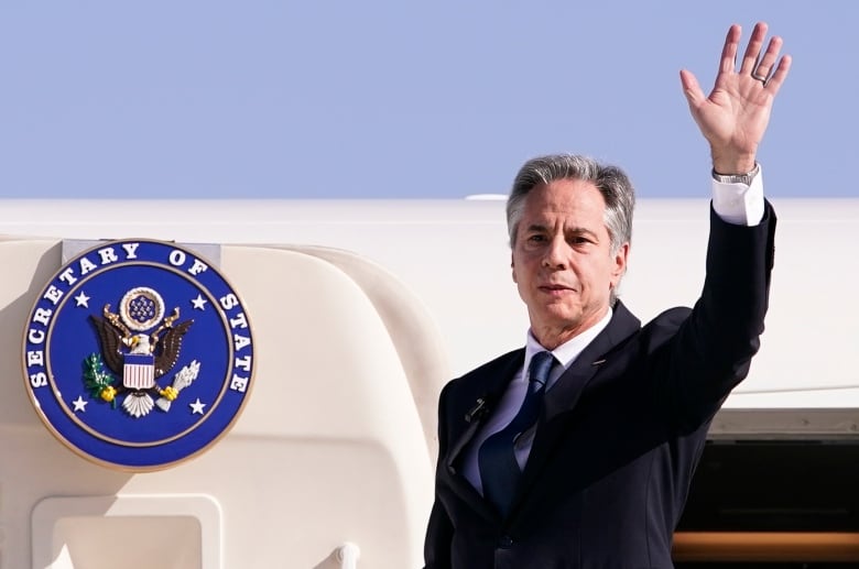 U.S. Secretary of State Antony Blinken waves,