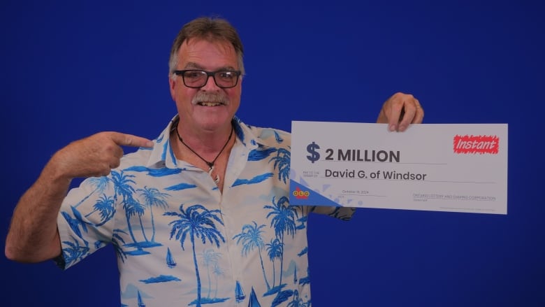 Man holding OLG lottery winning sign.