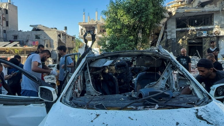 A frontal view of a completely wrecked vehicle.