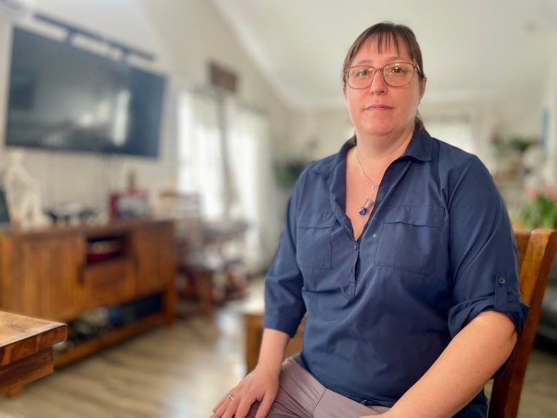 Vanessa LaVoie sits in her living room and looks at the camera. 