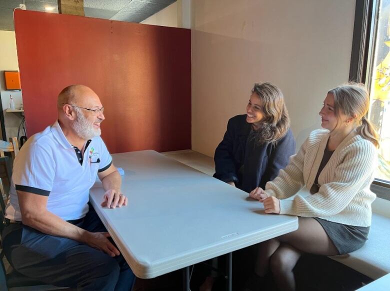 Business owner Tony Man-Son-Hing (left) speaks with business partners at their orientation day at the Cook Up location.