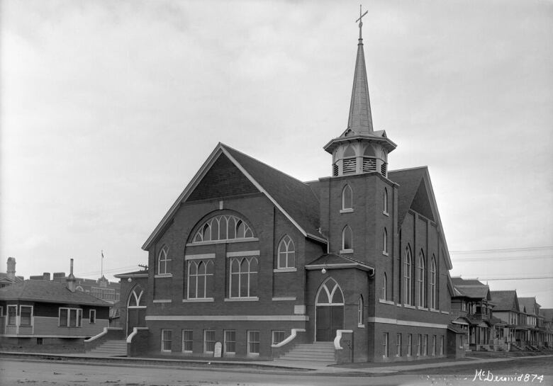 A brick building is in black and white.