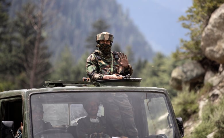 An Indian army soldier keeps guard on top of his vehicle as their convoy moves on the Srinagar- Ladakh highway at Gagangeer, northeast of Srinagar, Indian-controlled Kashmir, Tuesday, Sept. 1, 2020. India said Monday its soldiers thwarted provocative movements by Chinas military near a disputed border in the Ladakh region months into the rival nations deadliest standoff in decades. China's military said it was taking necessary actions in response,