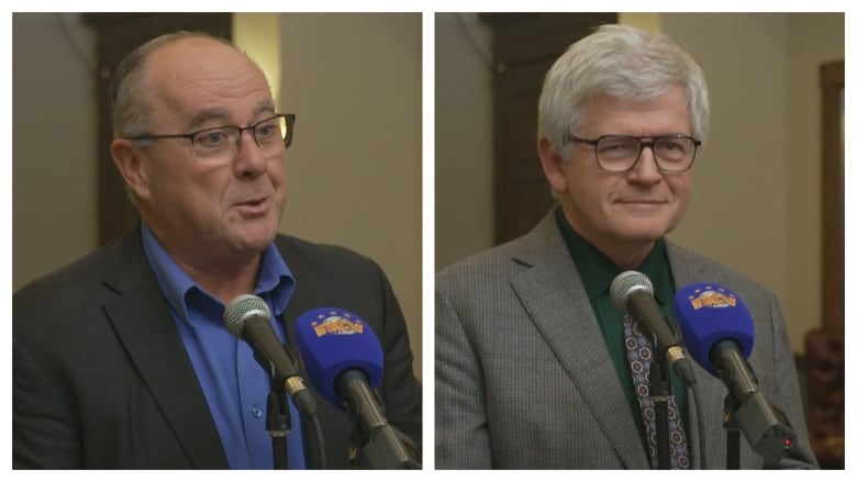 Two men wearing suits stand at a microphone.