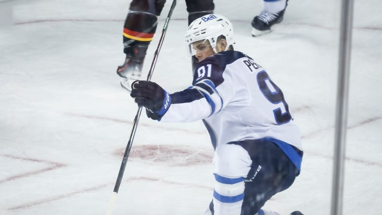 A hockey player celebrates a goal. 