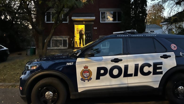  A police vehicle on a residential city street at dawn.