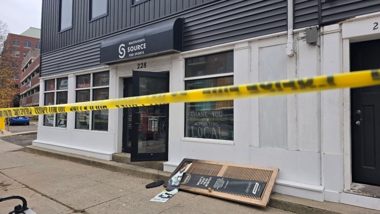 A storefront with caution tape in front of it