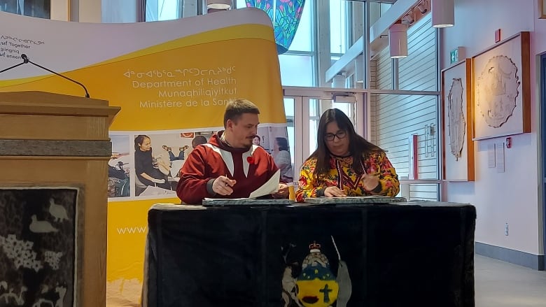 Nunavut Premier P.J. Akeeagok and Deputy Premier Pamela Gross sign the territory's fourth plan on suicide prevention.