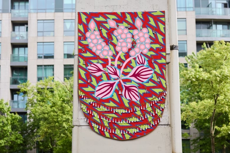 A giant red moccasin vamp with a design of a grape vine on it.