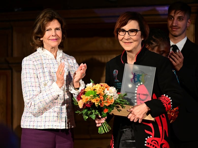 Cindy Blackstock, center, receives the World's Children's Prize from Queen Silvia for her fight for indigenous children's rights in Mariefred, Sweden.