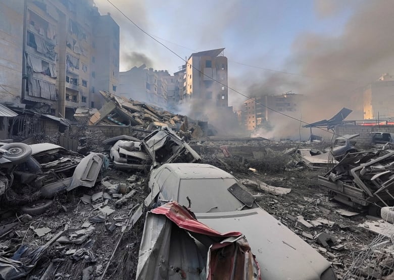 Wreckage of vehicles at a site of an aftermath of airstrikes.