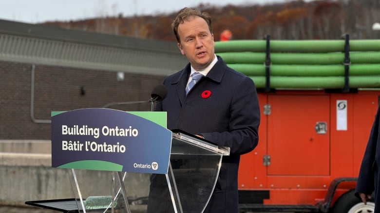 A guy stands at a podium