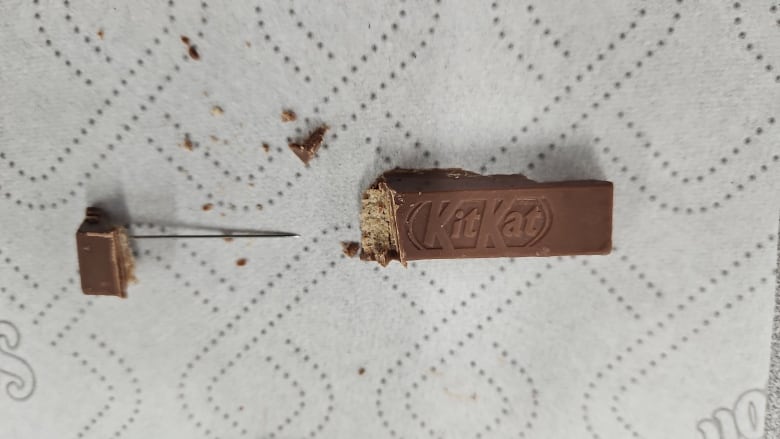 A Kit Kat chocolate bar with a needle inside of it