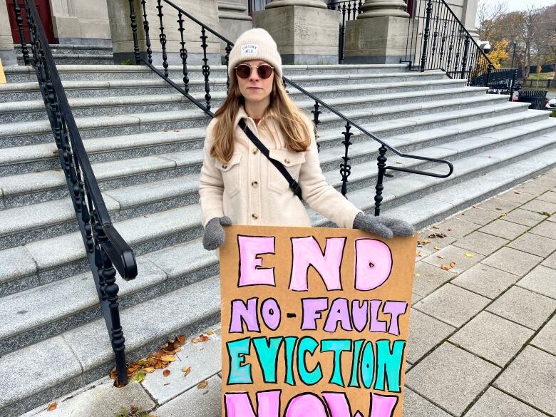 Woman holding a sign that says 