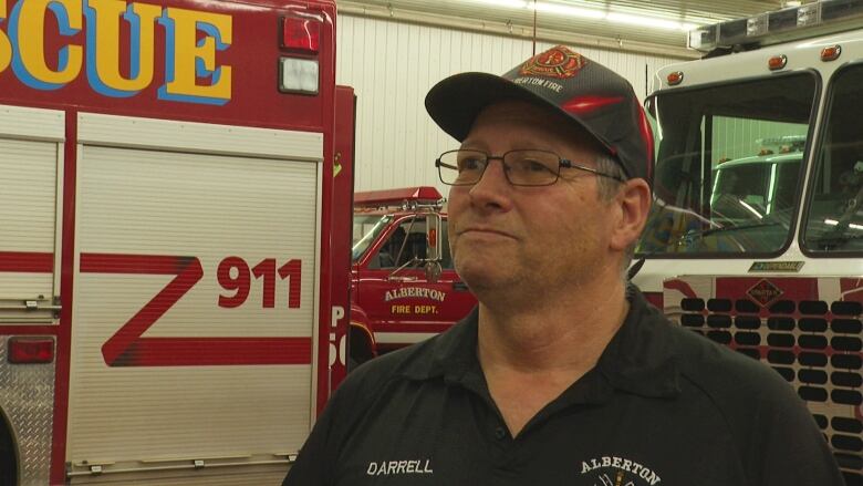 Man standing in fire station.