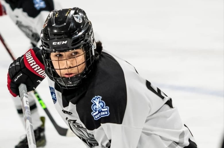 Marcus Odjick playing hockey.