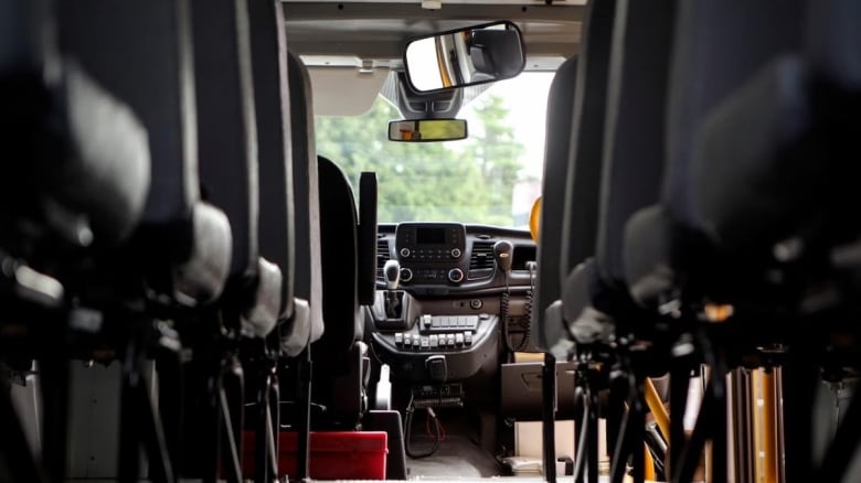 The interior of a school bus, from the rear.