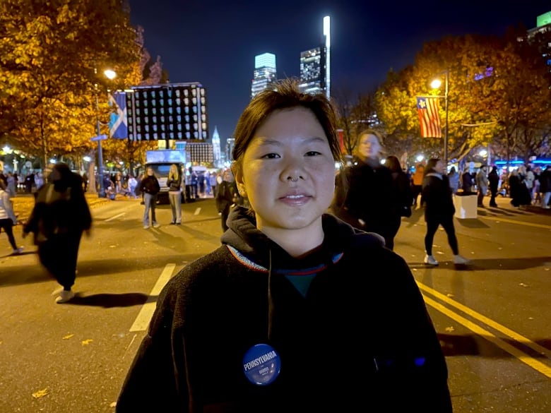 A woman in a black hoodie.