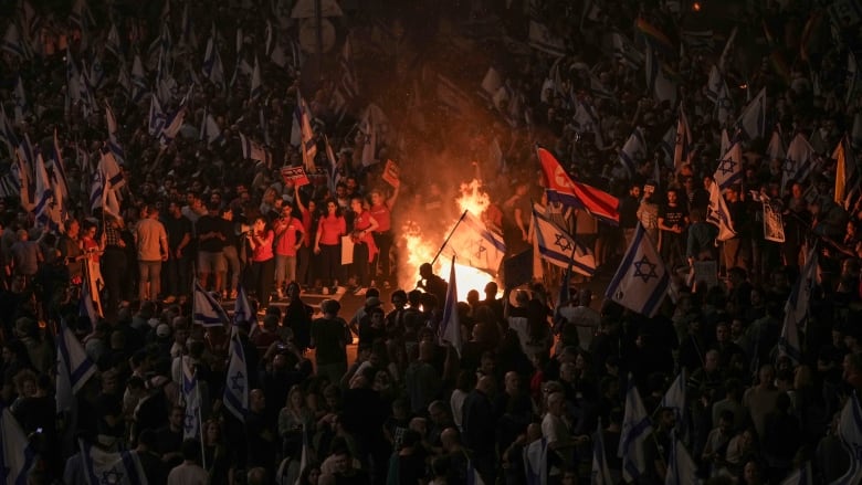 Protesters light a bonfire in Tel Aviv, Israel, at a protest held after Israeli Prime Minister Benjamin Netanyahu dismissed Yoav Gallant from his role as the country's defence minister.