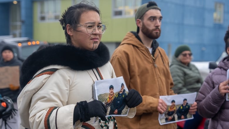 Protesters hold up picture