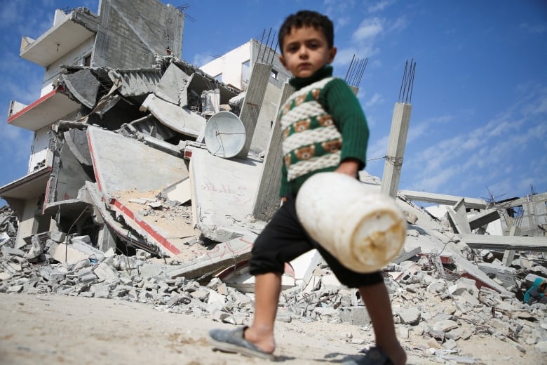 A Palestinian child walks past the rubble of a house destroyed in previous strikes during the Israeli military offensive, amid the Israel-Hamas conflict, in Khan Younis in the southern Gaza Strip November 6, 2024. 