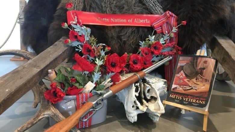 A gun, book and ribbon are part of a display to honour the service of Indigenous soldiers