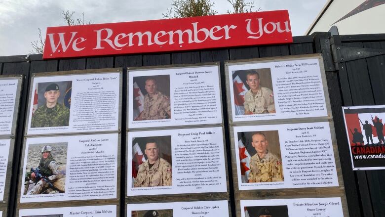 A fence with photographs and biographies from soldiers who fought in Afghanistan. 