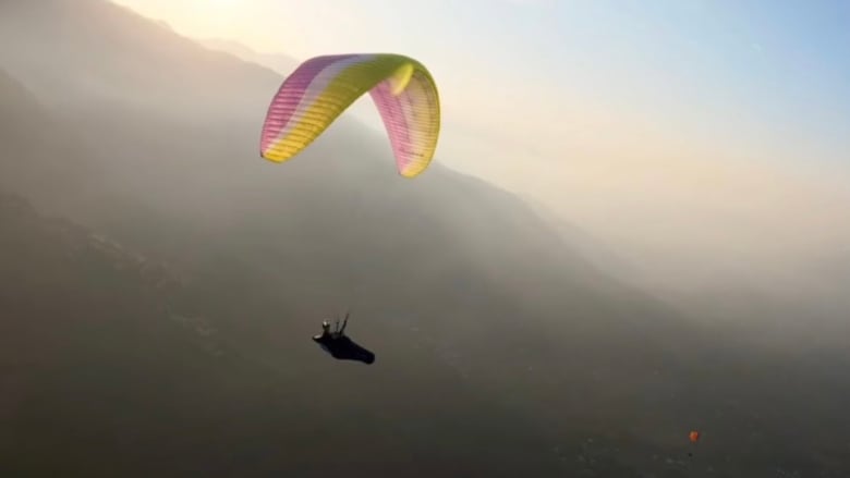 A paraglider in the air.