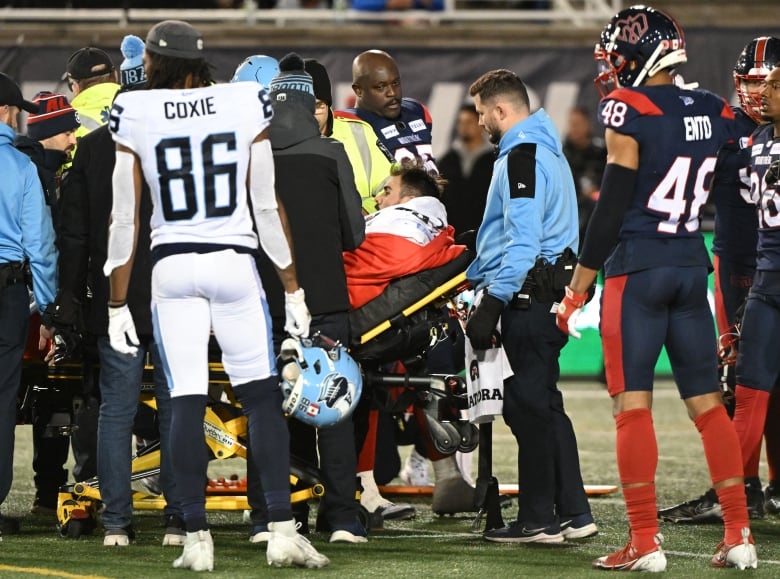 Toronto Argonauts male quarterback is taken off the field with a stretcher after an injury during third quarter CFL Eastern Conference Final football action against the Alouettes on Saturday, November 9, 2024 in Montreal.