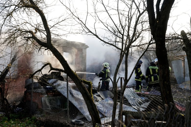 Firefighters work the scene of a drone strike. 