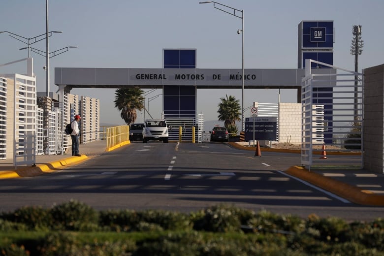 In this Wednesday, Jan. 4, 2017, file photo, cars exit the General Motors assembly plant in Villa de Reyes, outside San Luis Potosi, Mexico. Some of America's most popular cars and trucks are made in Mexico. Mexico's growing share of the auto market is a sore spot for President Donald Trump, who has threatened to impose border taxes on Mexican imports to force companies to make cars in the U.S.