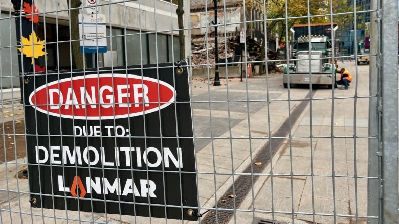 A view through a fence onto a construction site. 