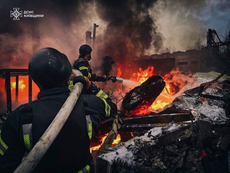 In this photo provided by the Ukrainian Emergency Service on Nov. 13, 2024, rescue workers put out a fire in a building destroyed by a Russian strike in Brovary, outside Kyiv, Ukraine.