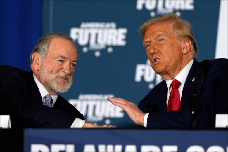 Republican presidential nominee former President Donald Trump talks with former Arkansas Gov. Mike Huckabee during a roundtable at the Drexelbrook Catering & Event Center, Tuesday, Oct. 29, 2024, in Drexel Hill, Pa.