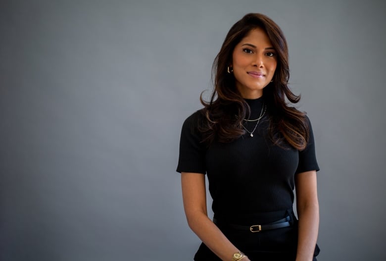 Photo of Israa Nasir, a south Asian woman in a black blouse.