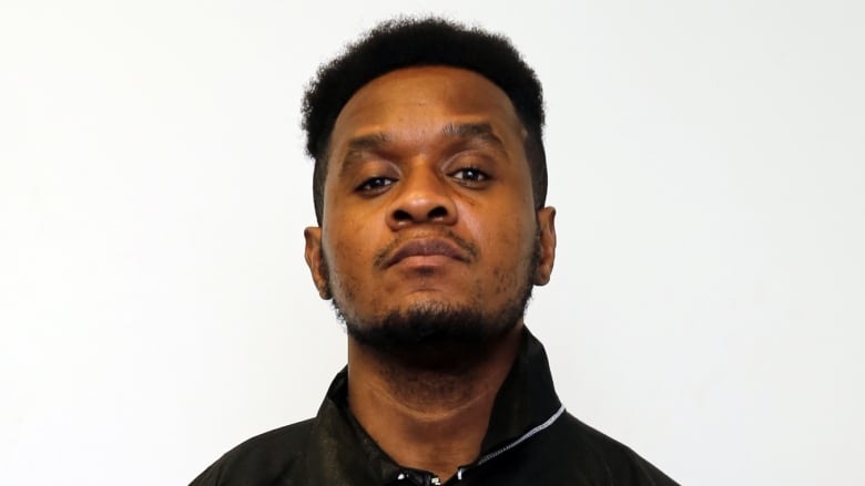 A police mug shot of a man's face.