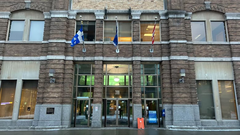 Brown building with Quebec and Canada flags