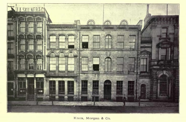 a black and white photo of three-storey brick buildings