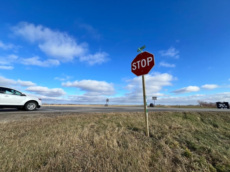 A stop sign in a road intersection. 