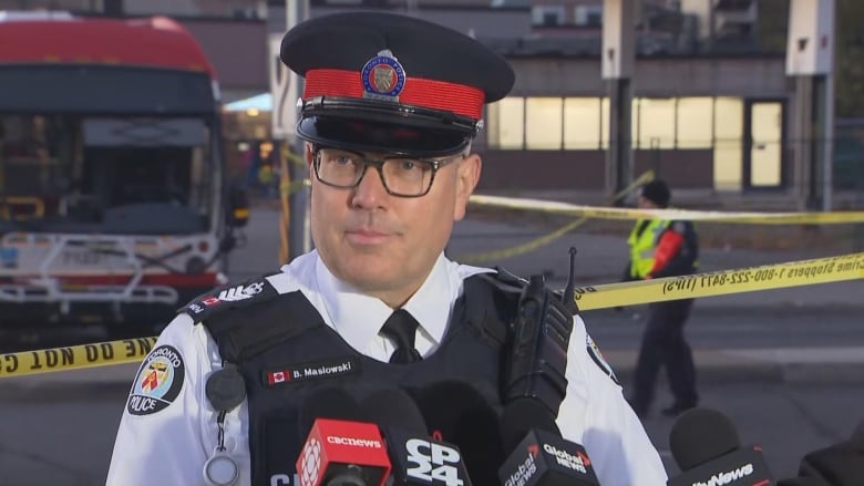 Photo of a police officer at a media scrum