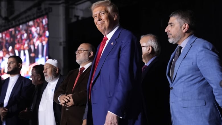 Donald Trump stands alongside local Muslim leaders in Novi, Mich., Oct. 26, 2024. 