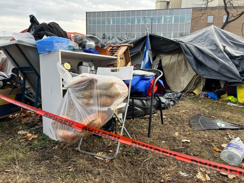 An outdoor space with tents and various items.