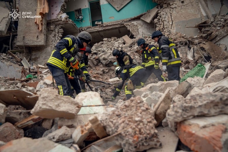 In an image supplied by the Press service of the State Emergency Service of Ukraine, rescuers work at a site of a residential building hit by a Russian drone strike, amid Russia's attack on Ukraine, in the town of Hlukhiv, Sumy region, Ukraine November 19, 2024. 