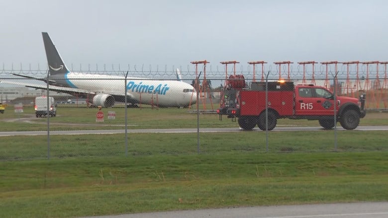 A Prime Air pane is pictured on green grass at YVR. 