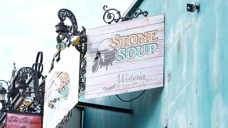 A sign reads 'Stone Soup Wisteria Community Association.'