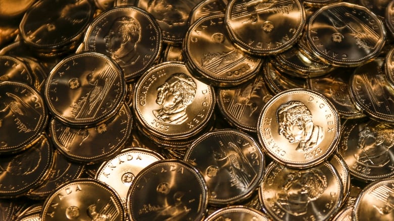 Loonies with the the effigy of King Charles on them are struck at an event celebrating the first coin struck at the Royal Canadian Mint in Winnipeg on Tuesday, November 14, 2023.